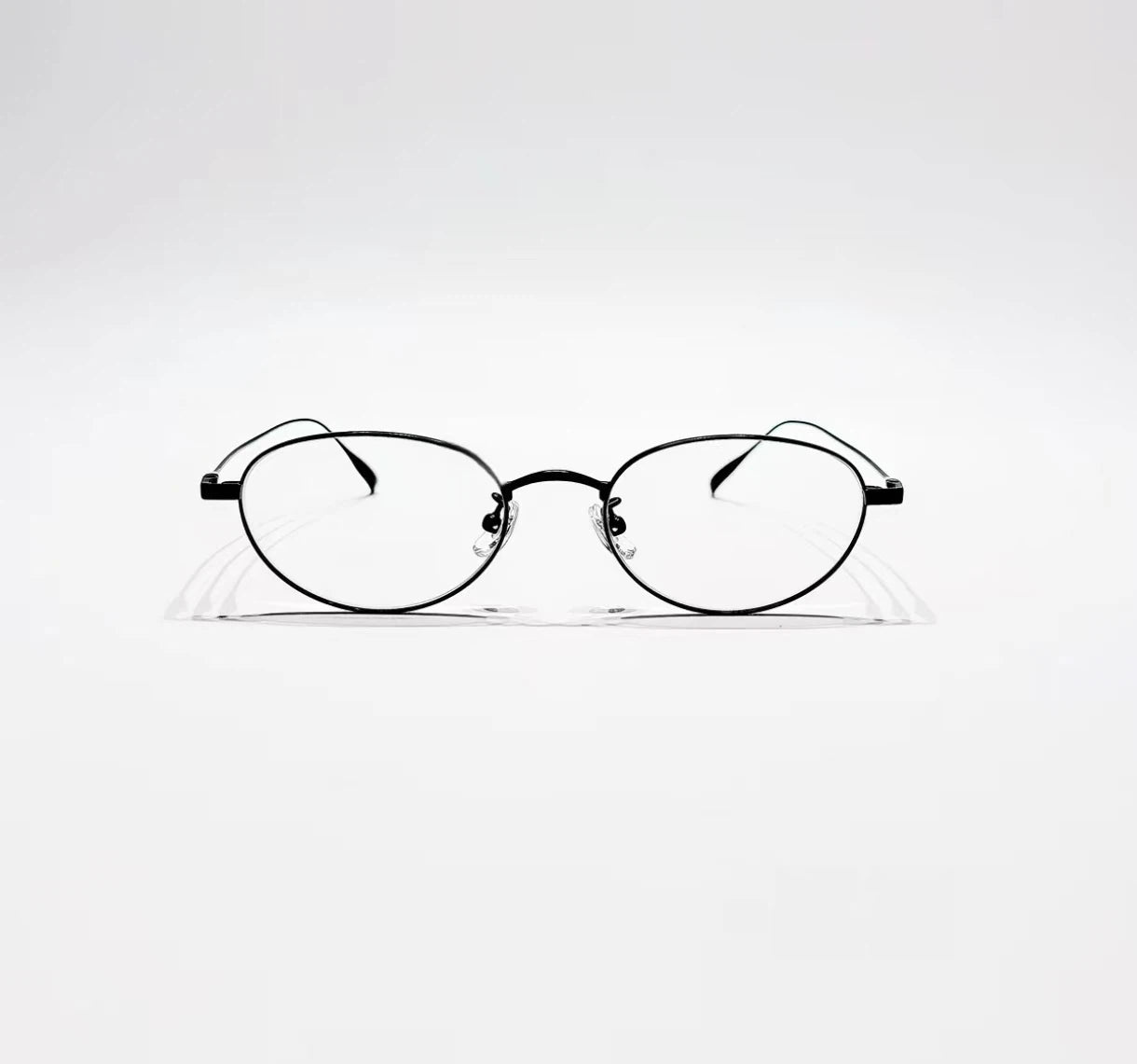Black women's titanium small oval full-rim glasses, front product view