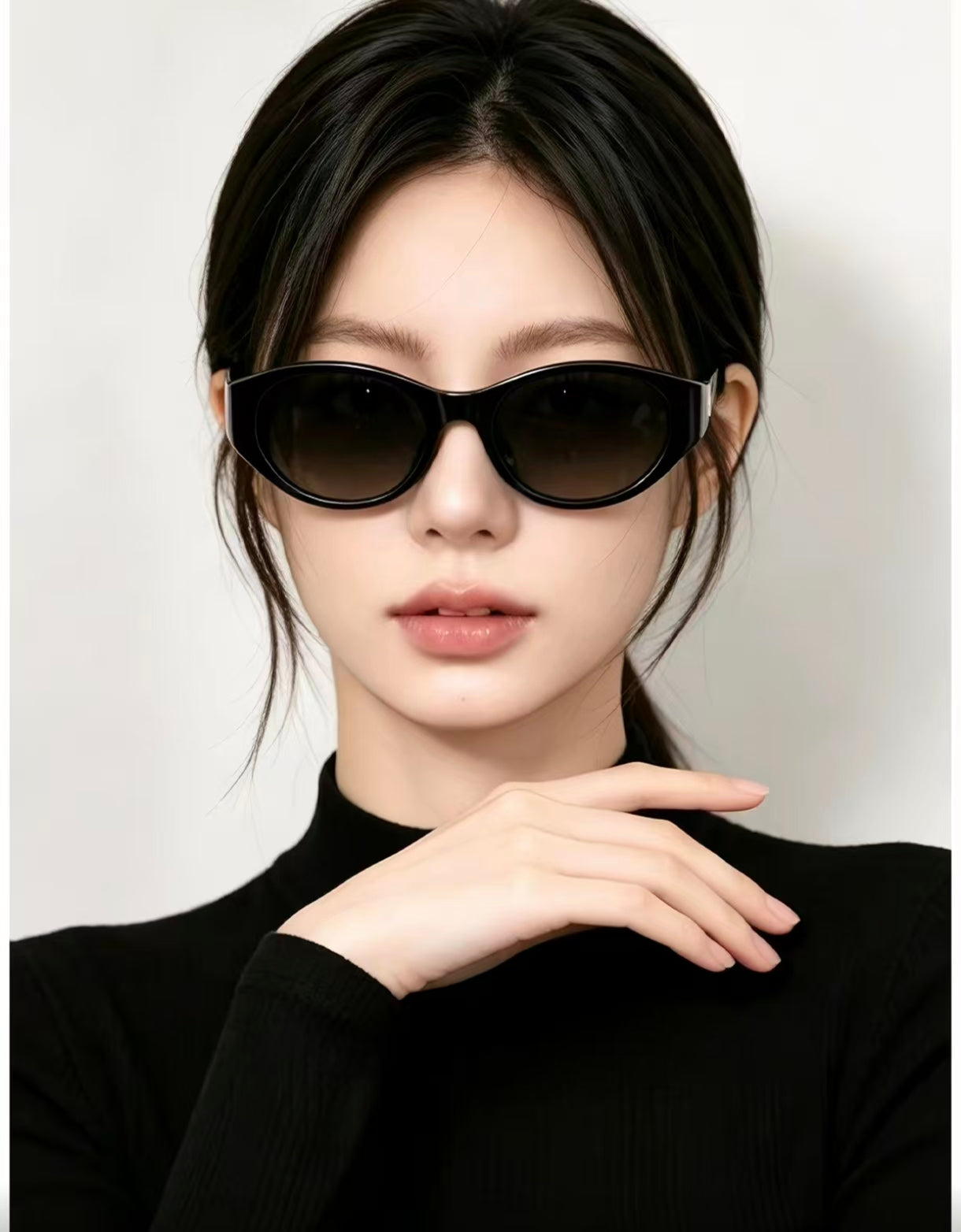 Adult woman wearing Glossy Black cat-eye sunglasses, close portrait