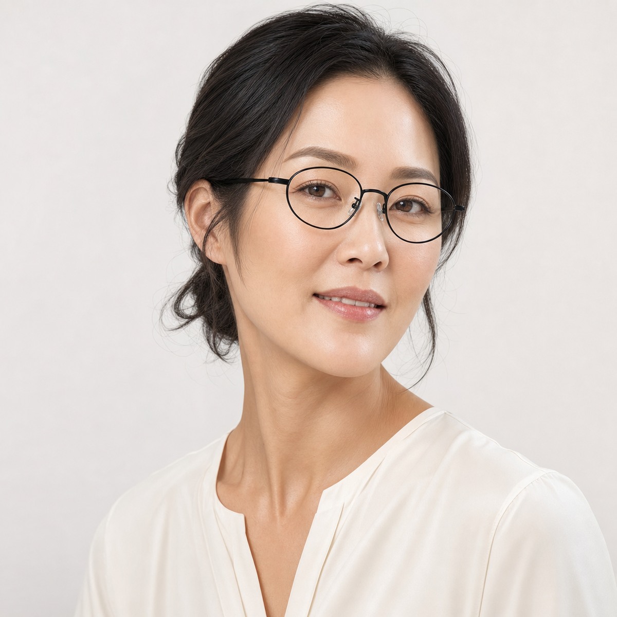 Black women's ultra-light semi-titanium oval full-rim glasses worn by an adult Mature East Asian Woman