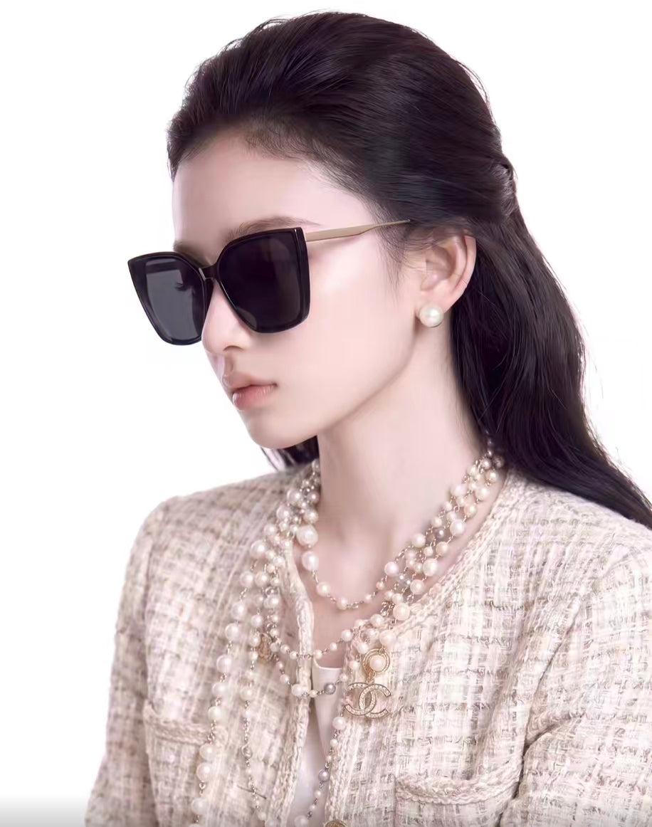 Woman wearing black full-rim oversized square tr90 sunglasses, side portrait