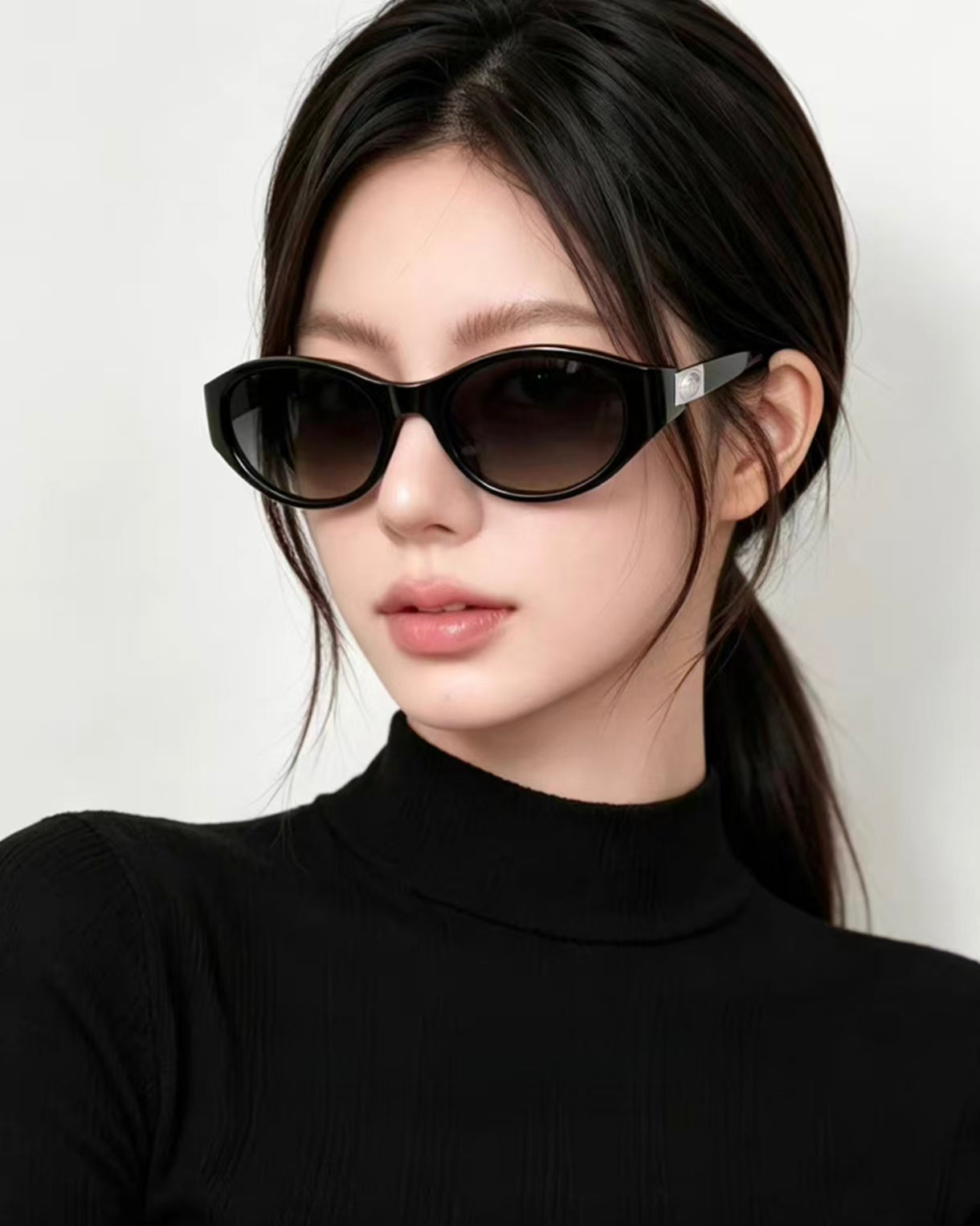 Adult woman wearing Glossy Black cat-eye sunglasses, front portrait