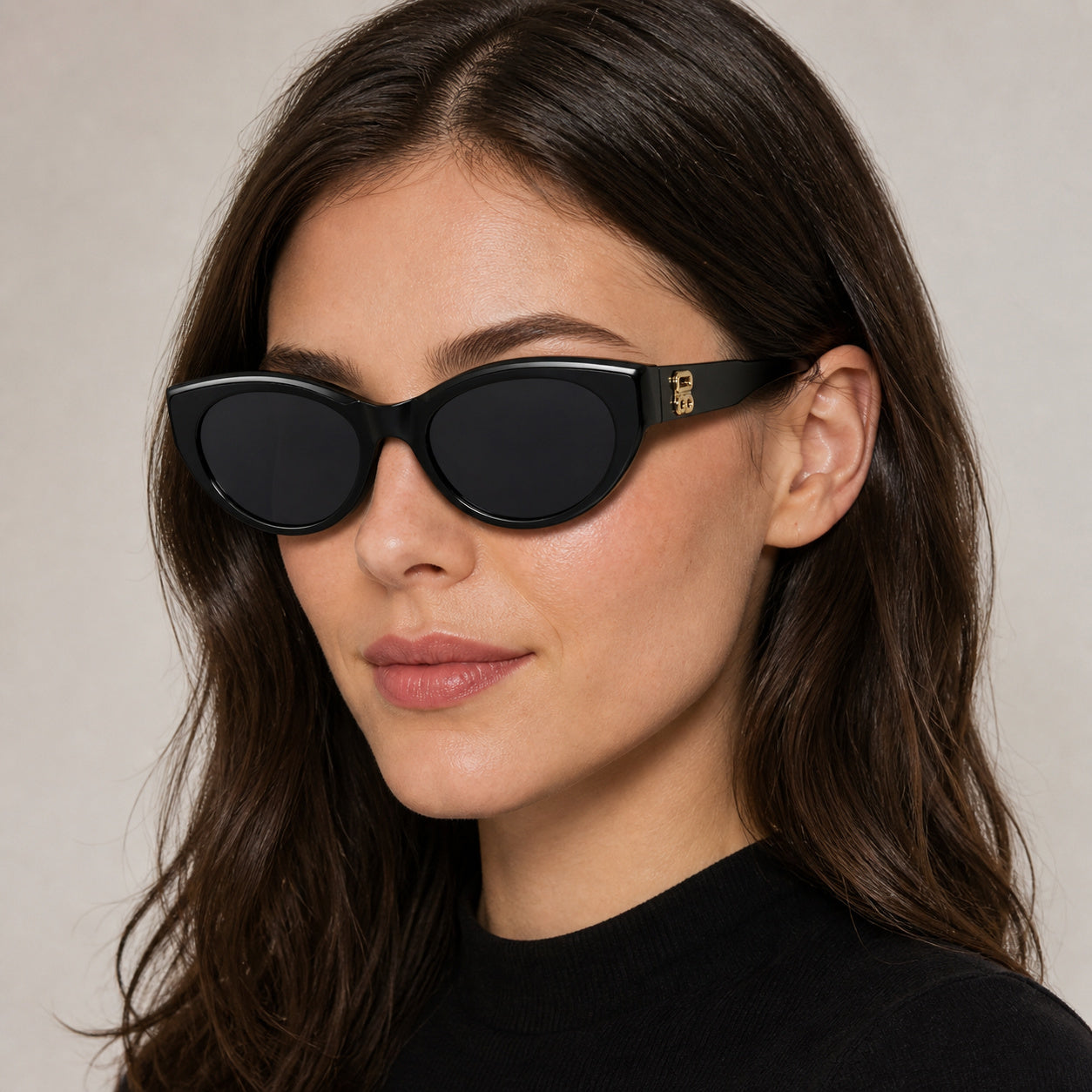 charcoal gray cat-eye sunglasses worn by an attractive clearly adult young White or East Asian woman