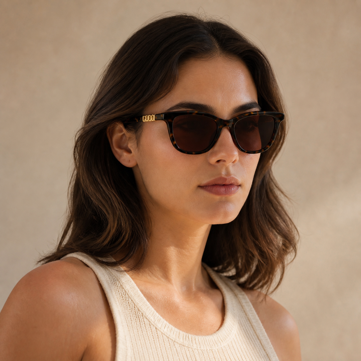 Adult model wearing Brown Gucci Luxury Women’s Brown Geometric Sunglasses, lifestyle view 1