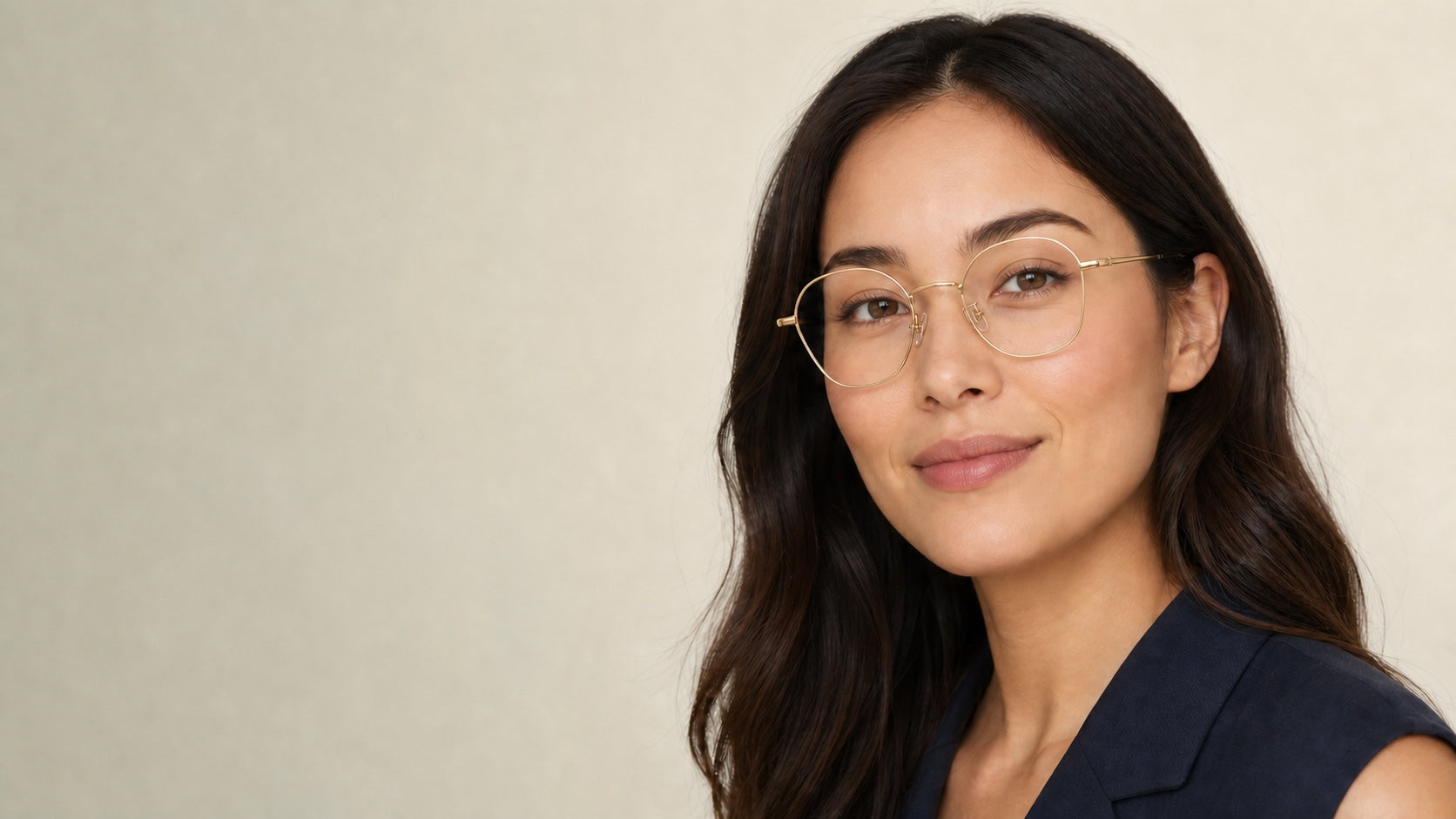 Woman wearing lightweight gold geometric prescription glasses