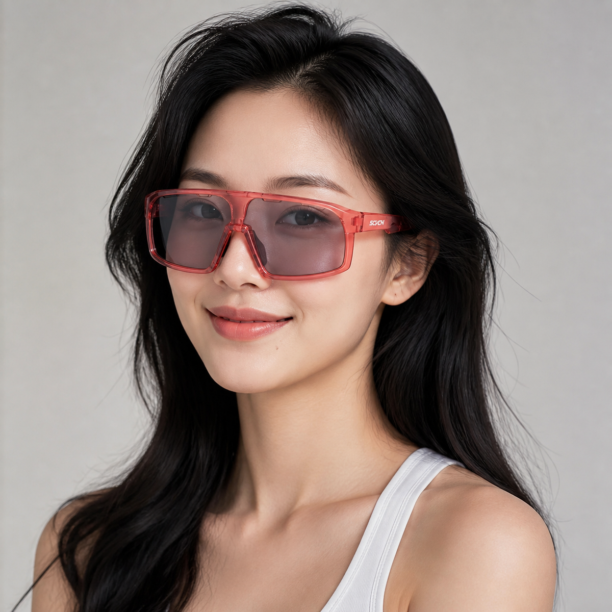 Glossy Crystal Pink Frame/Photochromic Grey Lens eyewear, worn by an adult model, front fit