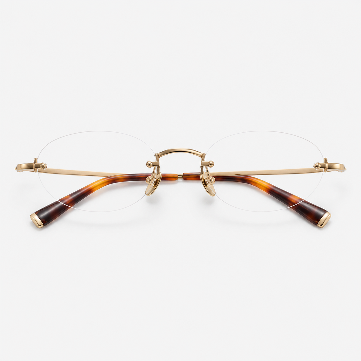 Gold/Tortoise women's pure titanium and acetate rimless rounded oval glasses, front product view