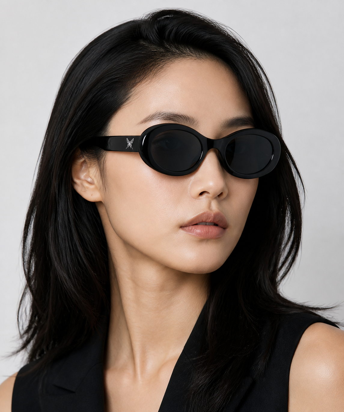Women’s Black full-rim oval cat-eye sunglasses, front adult model fit
